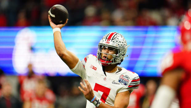 Dec 31, 2022; Atlanta, Georgia, USA; Ohio State Buckeyes quarterback C.J. Stroud (7) passes the ball against the Georgia Bulldogs during the third quarter of the 2022 Peach Bowl at Mercedes-Benz Stadium. Mandatory Credit: John David Mercer-USA TODAY Sports